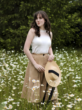 A girl wears a lace ruffle top and a skirt